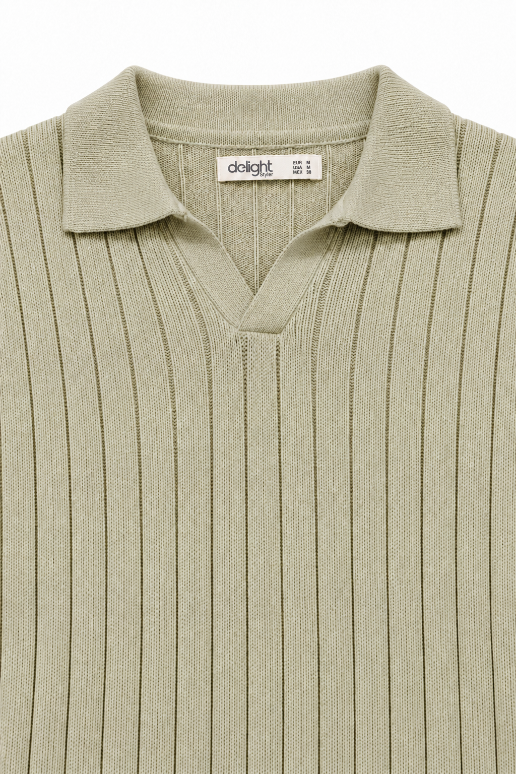 Close-up of sage green polo showing the buttonless collar and vertical knit texture